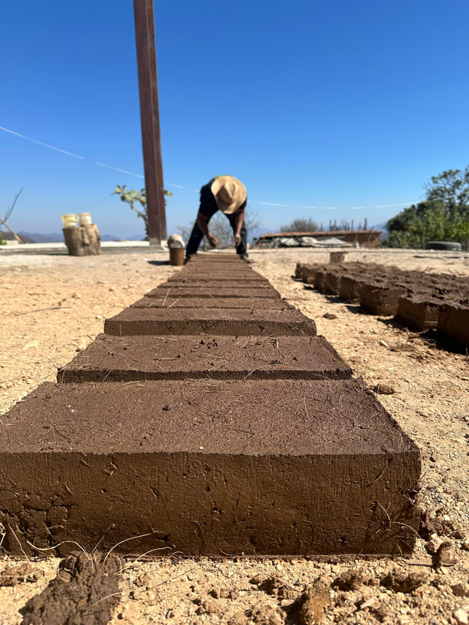 Image of people building kitchens and patios using mezcal by-products