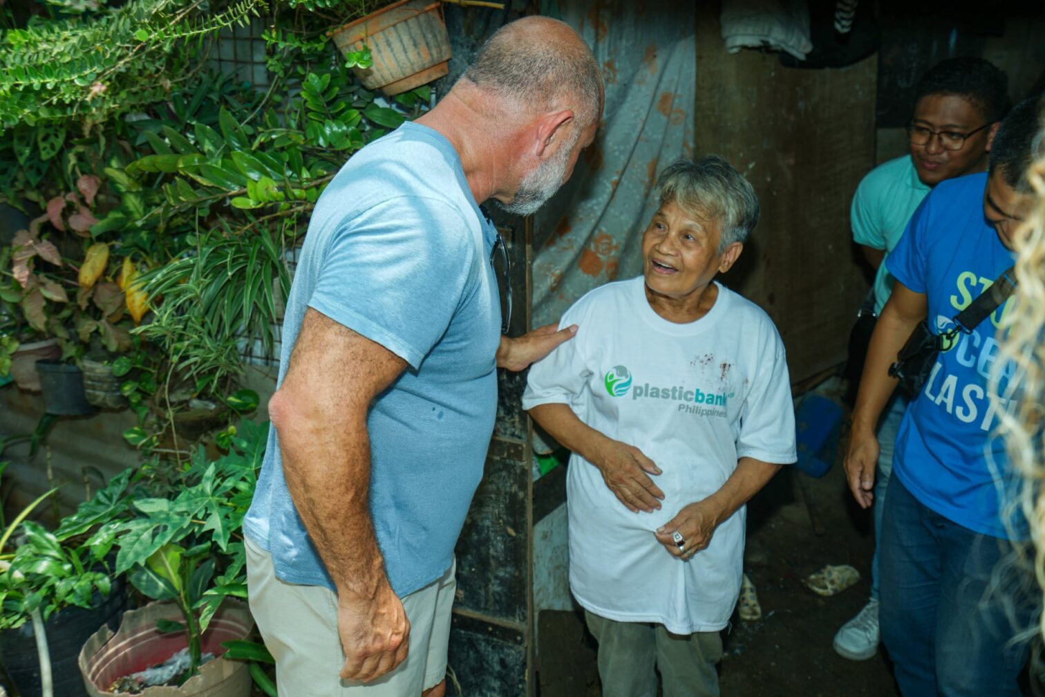 David Kats talking about Plastic Bank with a woman